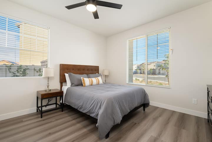 Bedroom #2: Queen bed with a workspace desk and smart LED TV.