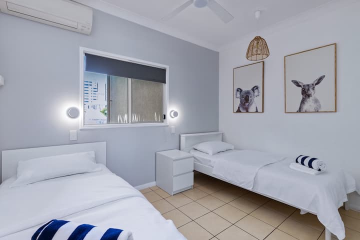 2 single beds with split system air conditioning and ceiling fan.