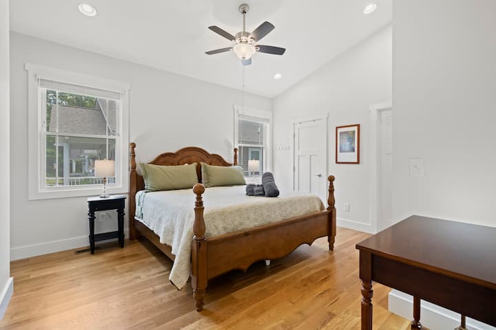 Large primary bedroom includes a king size bed, en-suite bathroom with double vanity, and a spacious closet. 