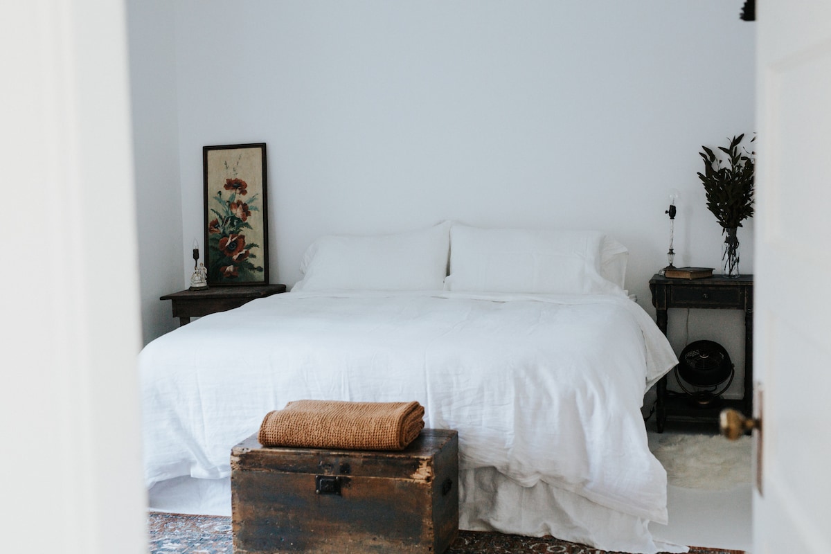 The Garden Bedroom is the master space in this home.  The trickling pond and the rich morning light is ever-present.  Sleep like a king on the large bed, steeped in our purest white intentions.  We envision this space as a cloud drifting carelessly. 