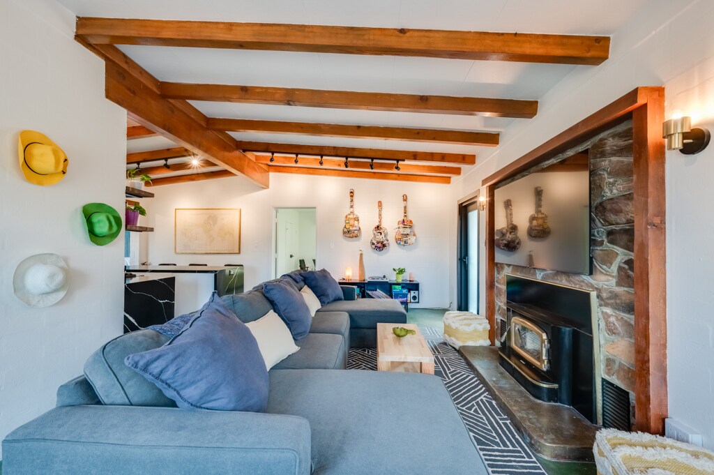 Giant comfy sofa surrounded by desert vibes | Candle-lit fireplace (NOT wood/gas)