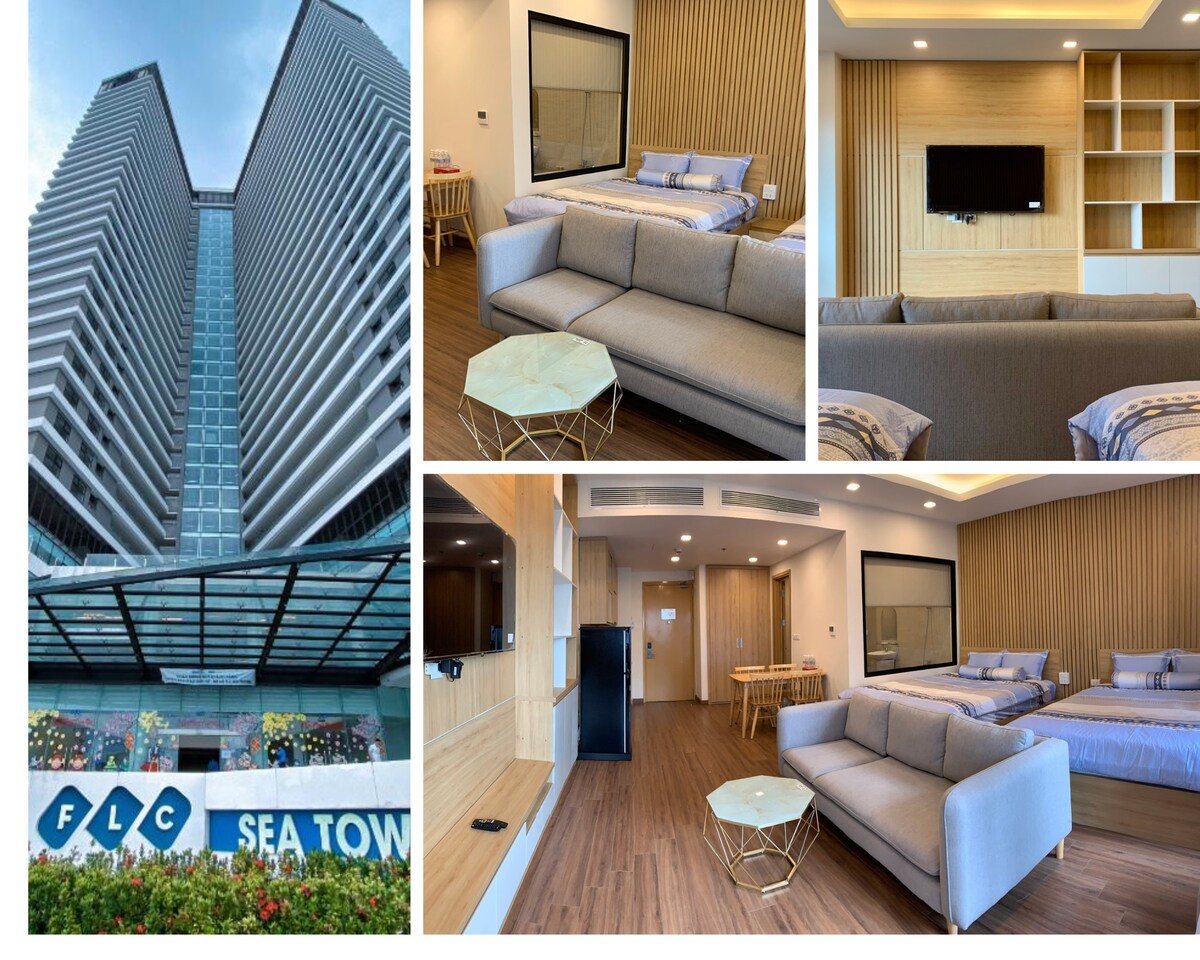 The exterior showcases a modern high-rise building with a prominent entrance adorned by colorful landscaping. Interior views present a spacious living area furnished with a light gray sofa and a coffee table. Two neatly made beds are featured in a serene sleeping area, complemented by wooden accents.
