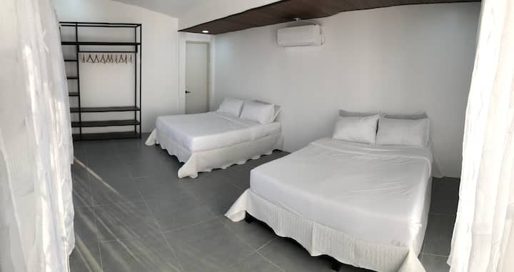 The upstairs bedroom has 2-queen sized beds + a twin pullout. This spacious room is also a perfect hang-out spot for friends and family and for planning for your next trip!