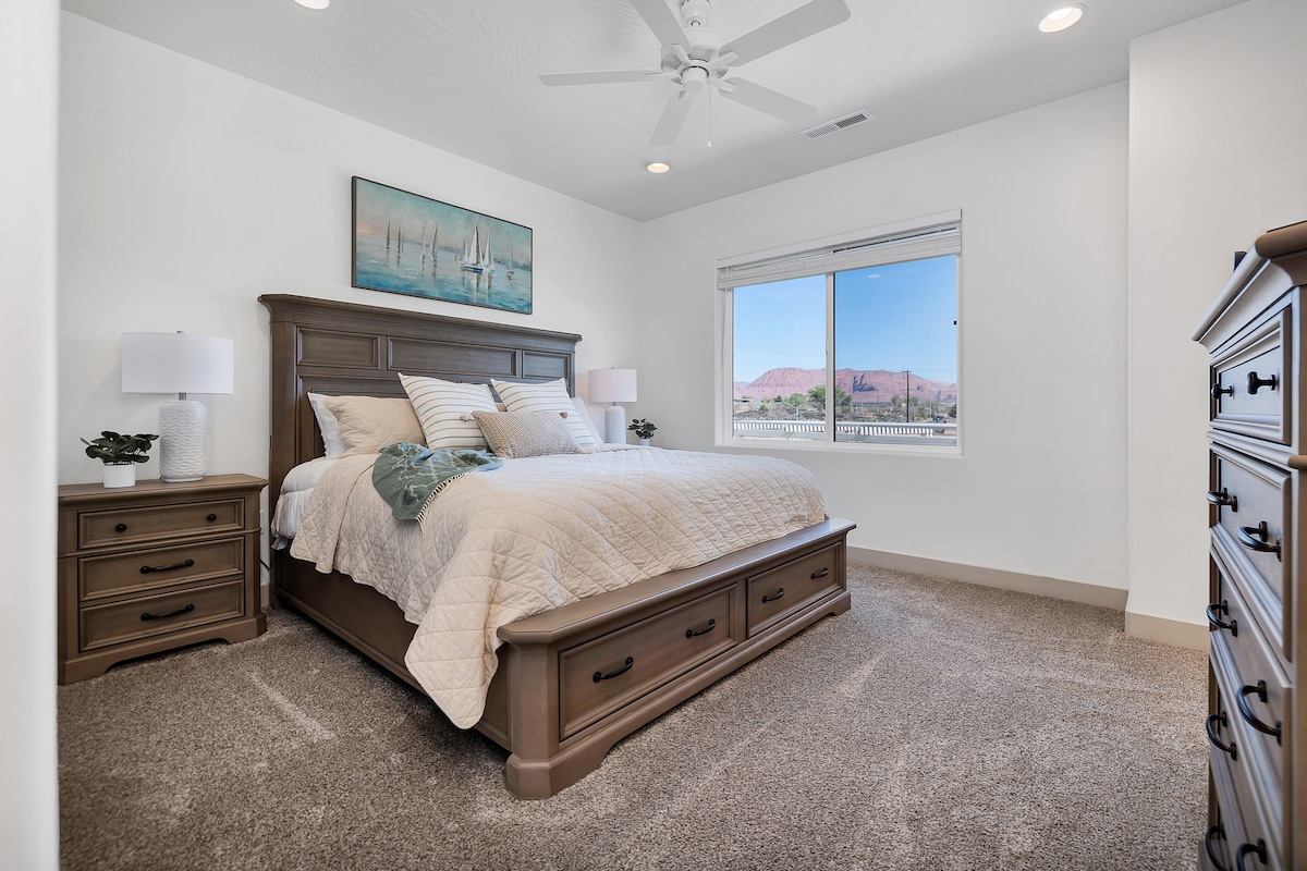 Chambre principale avec commode, tables de nuit et lampes