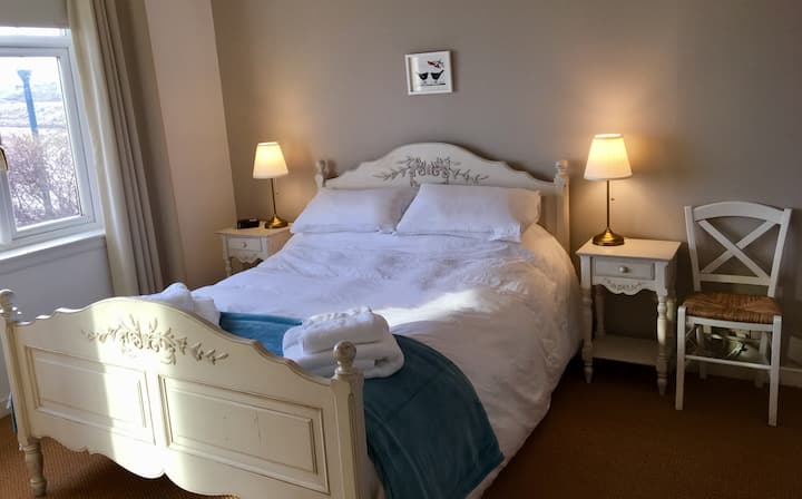 King size bedroom with wardrobe, dressing table, further built in wardrobe and sea view