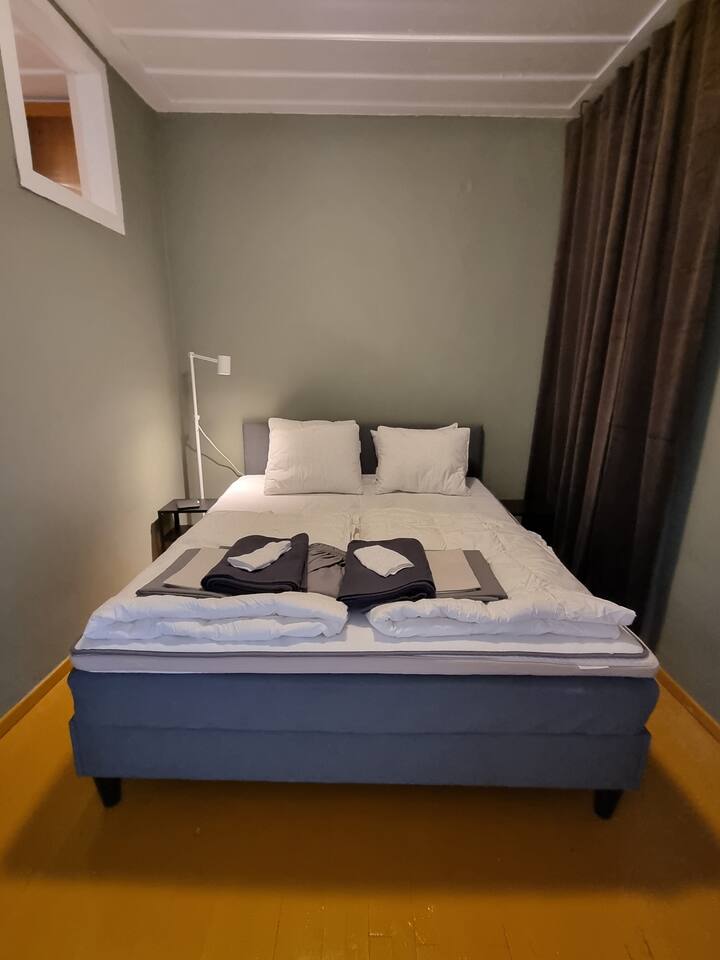 Spavaća soba u zemljanim tonovima koji poboljšavaju opuštanje i odmor. Bračni krevet ima udoban madrac, nadmadrac i svu potrebnu posteljinu za svako godišnje doba.