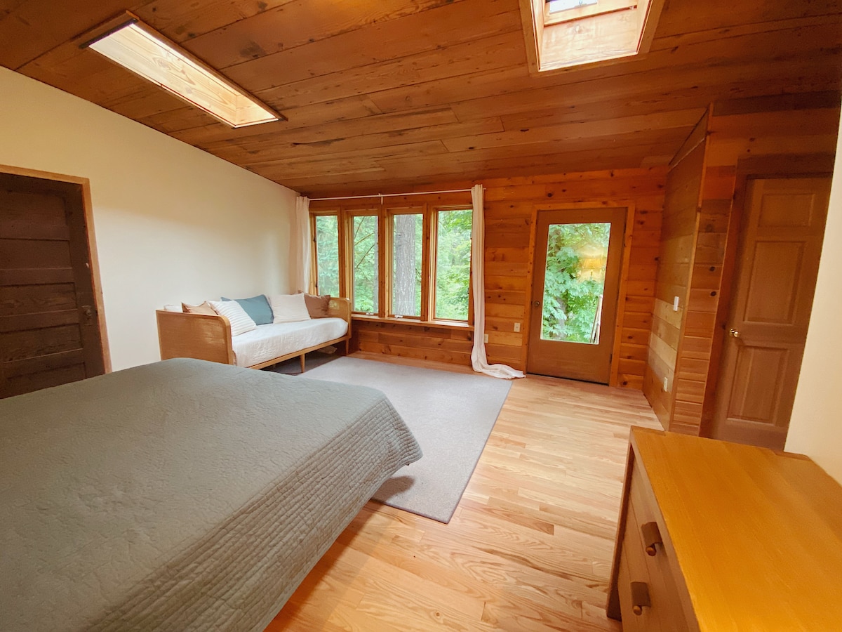 primary bedroom with gorgeous wood and skylights! 