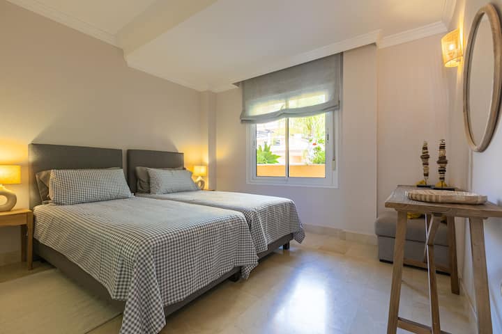 Cozy second bedroom with twin beds, warm lighting, ample storage, and a stylish decor—perfect for a restful and relaxing stay.







