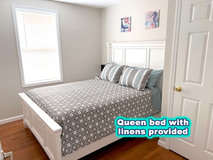 The bedroom features a queen bed, closet and smart TV. Linens and pillows are provided. 