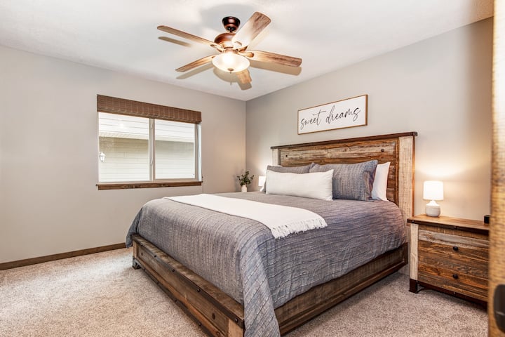 The master bedroom on the main floor features a large walk-in closet (perfect for a Pack 'n Play), king bed, Smart TV, iHome, and full bathroom