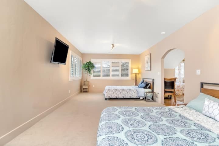 1200 sqft master suite upstairs with 2 queens and 1 king bed, attached bathroom, walk-in closet. This suite is always a hit with the kids as it has a second smart TV with Netflix access, along with board games and books. USB Ports in lamps.