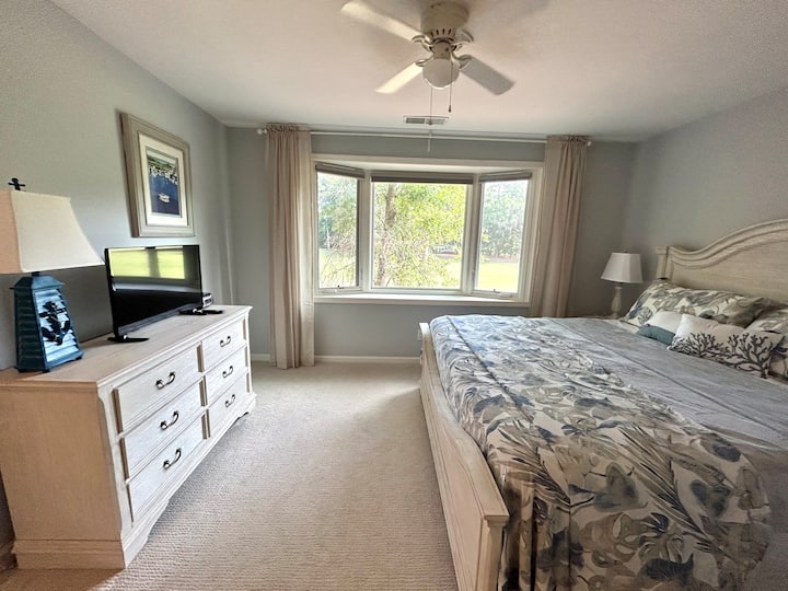 Wake up in luxury in the king-sized bed dressed in Tommy Bahama linens. Remote controlled blinds block out the light and linen drapes soften the bay window overlooking hole 1 of Shipyard's Galleon Golf Course.