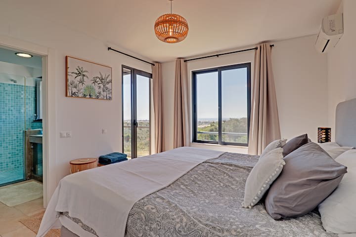 Master bedroom with a double bed, aircon, built in wardrobes, en suite bathroom and private terrace