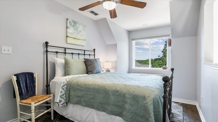Bedroom with loft window overlooking living room.