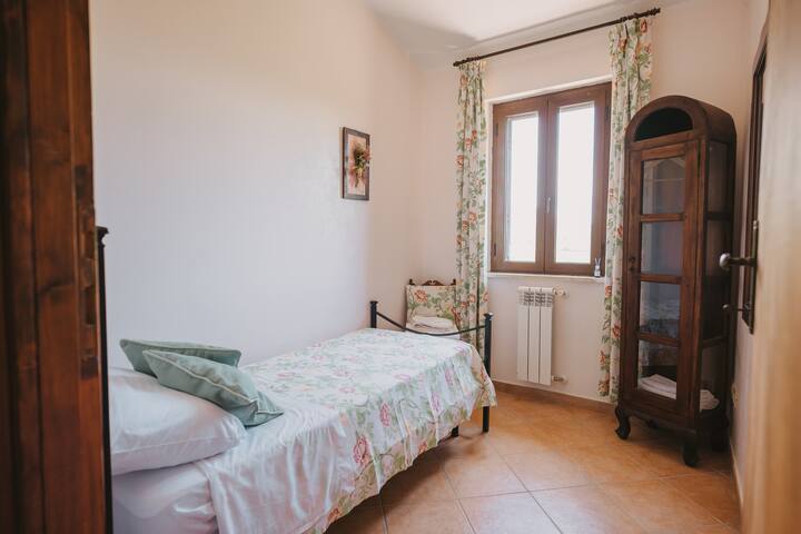 Windowed room with single bed and view of Lake Turano, upstairs.