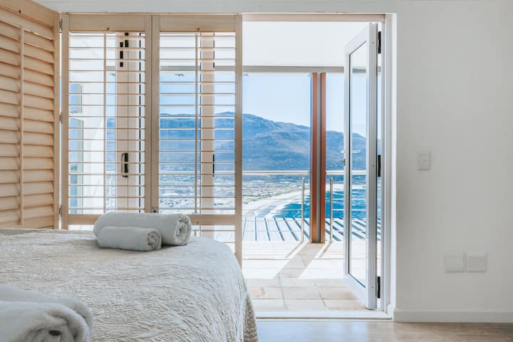 "Beige" bedroom with ocean views. Queen bed and connected through a full bathroom with kids bedroom (red room) 