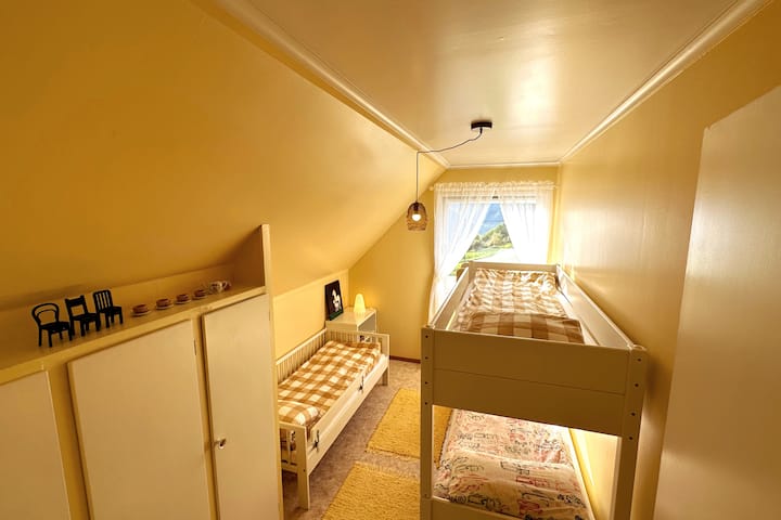 The childrens room with three beds, a few childrens books and board games. Also some paintings and drawings by our two girls. 
Btw: We hope you like yellow, someone did when they decorated this room :-)  