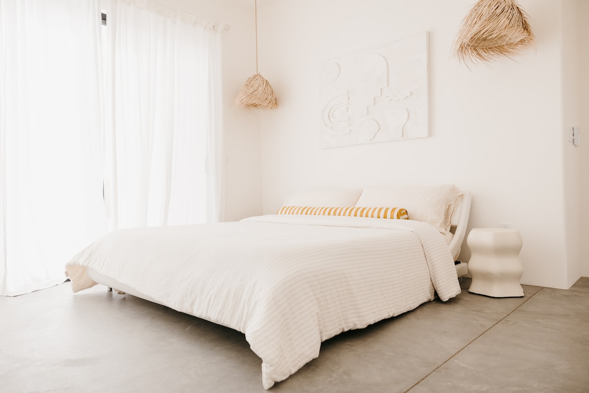 King sized bed with a cave pool view