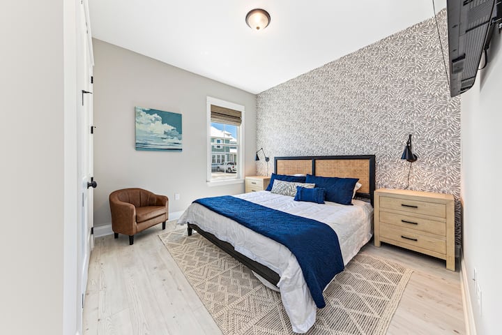 Bedroom 2 has great design details with custom wallpaper and artwork