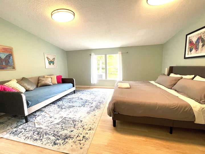 Master bedroom with king bed, twin daybed, and en suite bathroom.