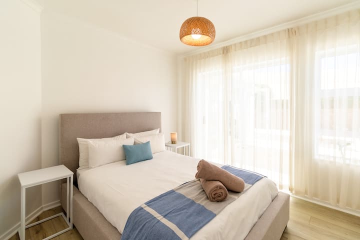 2nd bedroom with doors that leads to backyard area and pool