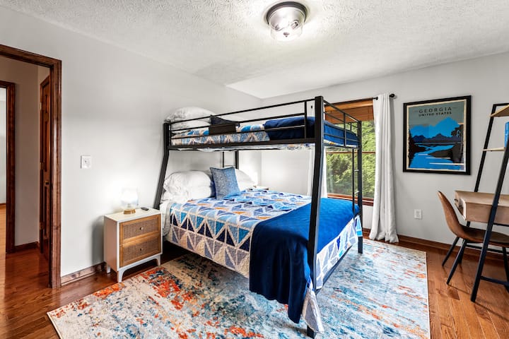 The second bedroom boasts a full XL over queen bed with bedside table on each side. A small desk provides a useful work space.