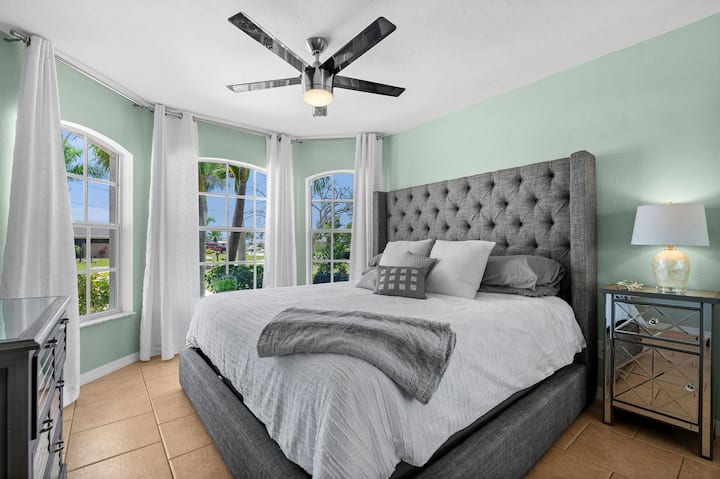 ห้องนอนรองพร้อมเตียงคิงไซส์วิวสวนทีวีและตู้เสื้อผ้าขนาดใหญ่