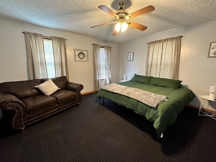 Dormitorio principal con cama tamaño king, sala de estar, armario, vestidor, TV inteligente y baño privado.