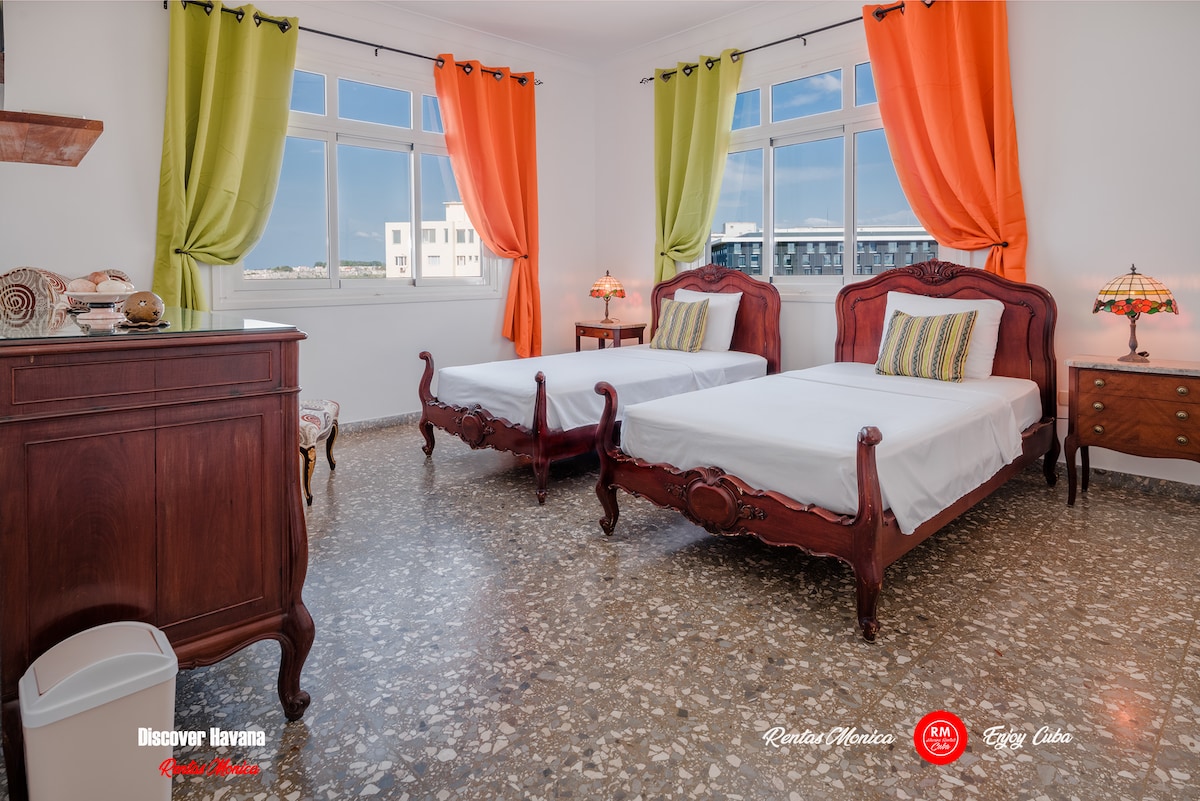 Bedrooms on the left side of the hall share a bathroom

One bedroom with 2 single beds, 50 inch smart TV, safe for documents and money, hair dryer and air conditioning