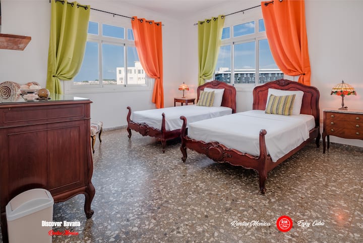 Bedrooms on the left side of the hall share a bathroom

One bedroom with 2 single beds, 50 inch smart TV, safe for documents and money, hair dryer and air conditioning