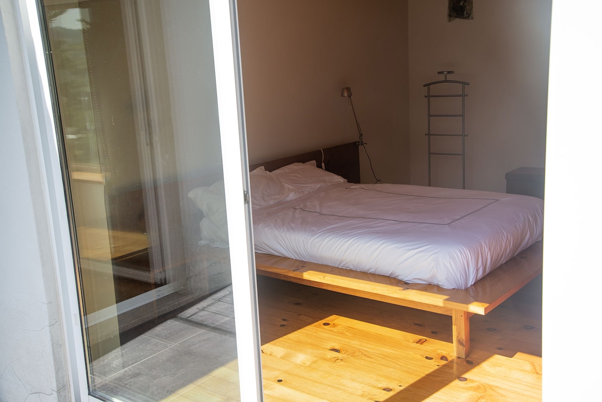 Bed with a 1,35 x 1,85 m orthopaedic mattress, and french windows to the balcony with a panoramic view over the forest surroundings.