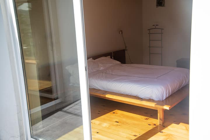 Bed with a 1,35 x 1,85 m orthopaedic mattress, and french windows to the balcony with a panoramic view over the forest surroundings.