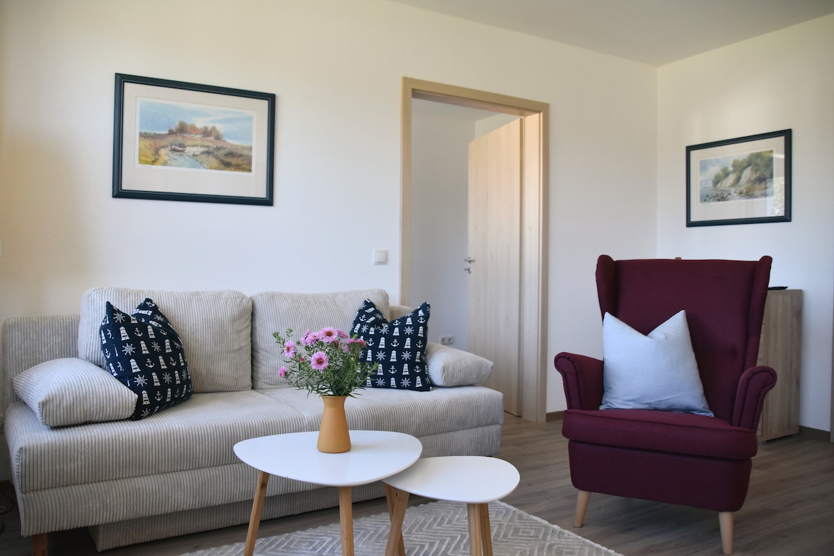 Obývacia izba s útulnou rozkladacou pohovkou a kreslom