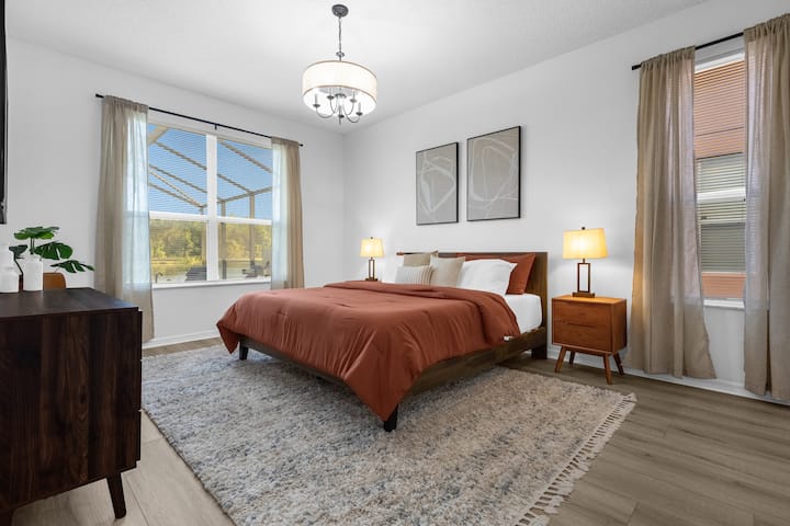 King-sized bed, with a firm, high quality mattress, furnished with a smart TV, walk-in closet, and ensuite bathroom.