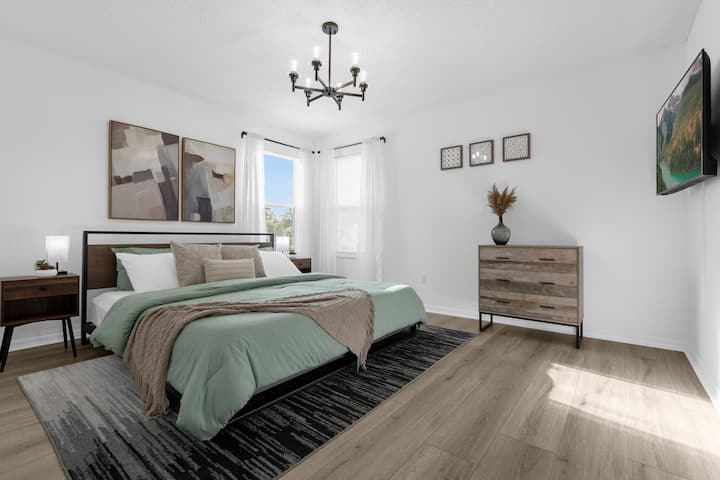 King-sized bed. Room is furnished with a smart TV, walk-in closet and ensuite bathroom.