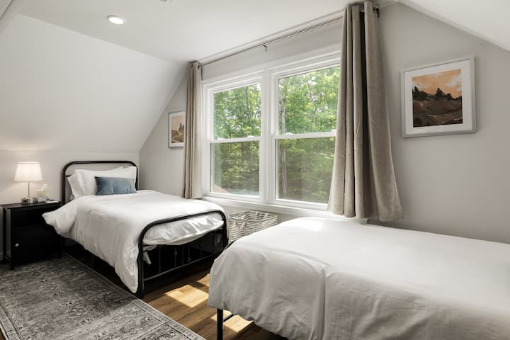 The secondary bedroom has two twin beds and large windows.  This soothing space is suitable for adults as well as our littlest guests!