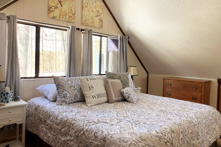 
"Nestled in comfort: The indulgent upstairs loft and master bedroom, featuring a blissful, comfy bed at Simple Pleasures Retreat."