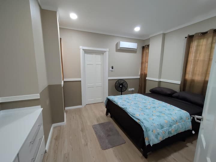 This is the primary bedroom with A/C unit and connected bathroom.