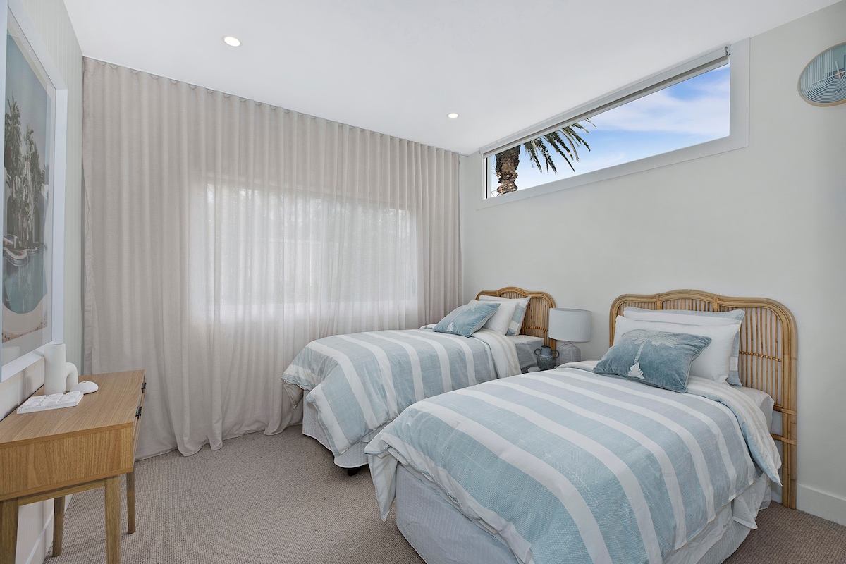 Twin Single Bedroom with standalone AC controls, build in wardrobe and automated blinds.