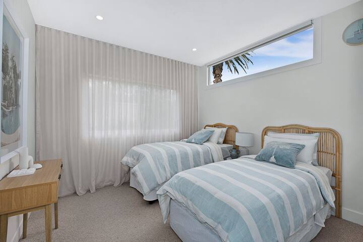 Twin Single Bedroom with standalone AC controls, build in wardrobe and automated blinds.