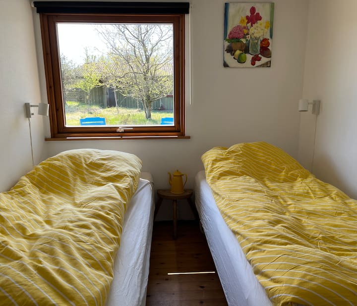 "La habitación amarilla", orientada al oeste. Dos camas individuales que se pueden juntar en una cama doble. Persiana enrollable opaca. 