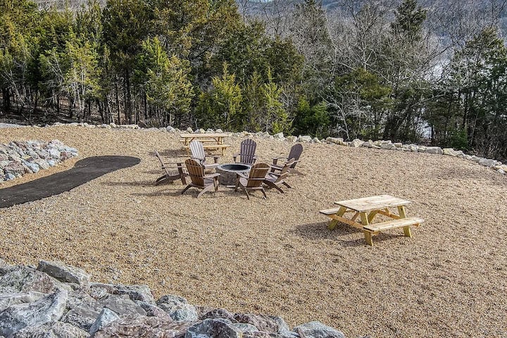 Community fire pit ring with Adirondack chairs overlooking the Ozark hills