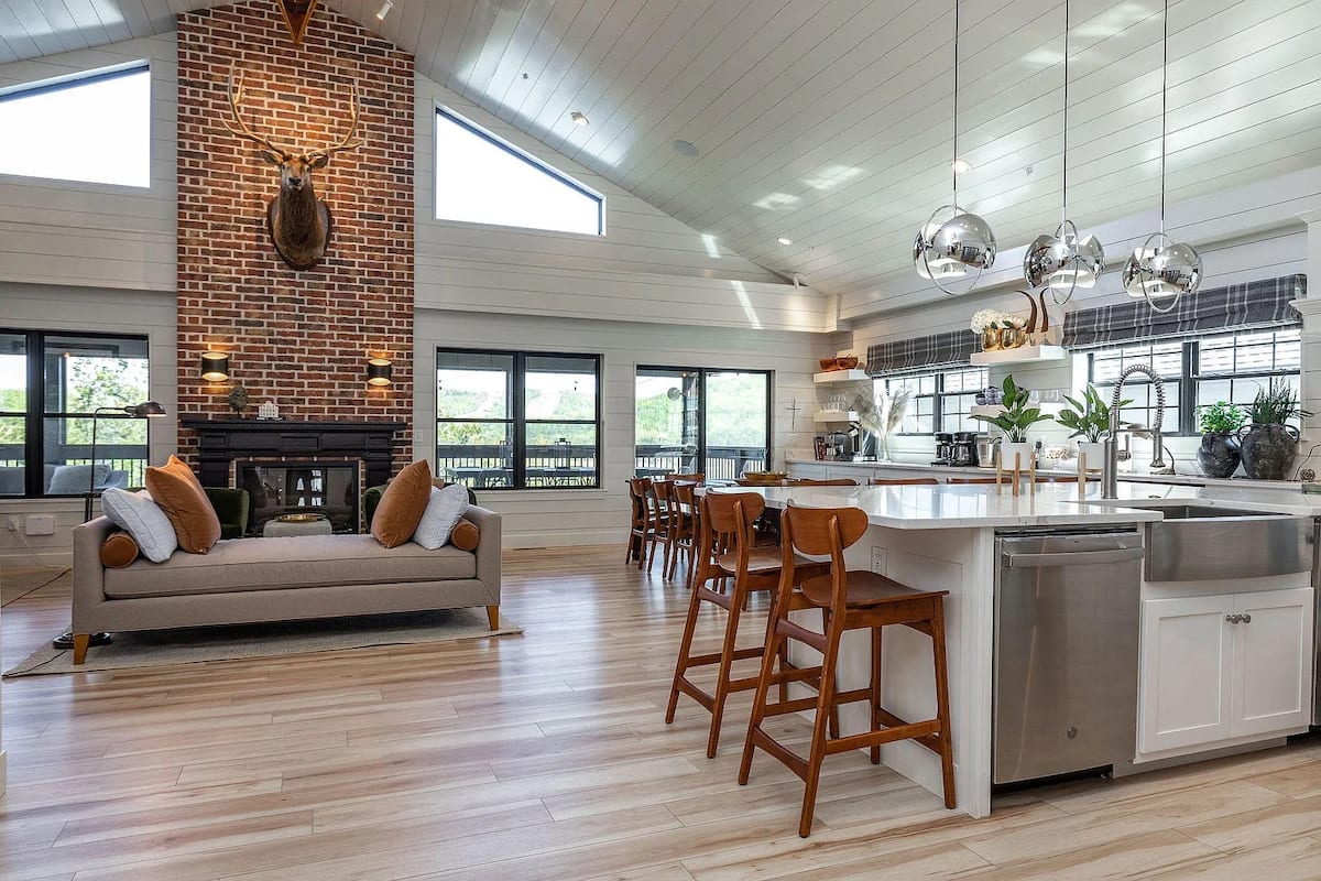 Open great room and kitchen with vaulted white shiplap ceiling