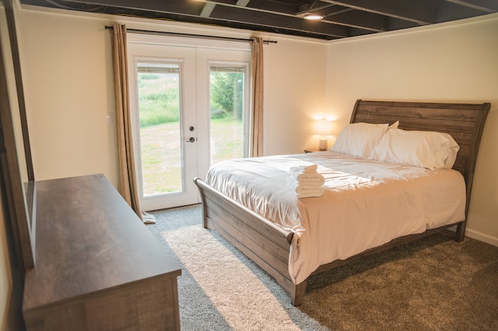 Doors lead out to backyard. Curtains and blinds in between the glass doors allow for privacy. Open them in the morning for a sunshine wakeup!