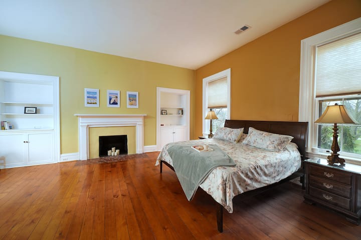 Second floor king sized bedroom with lounging area. 