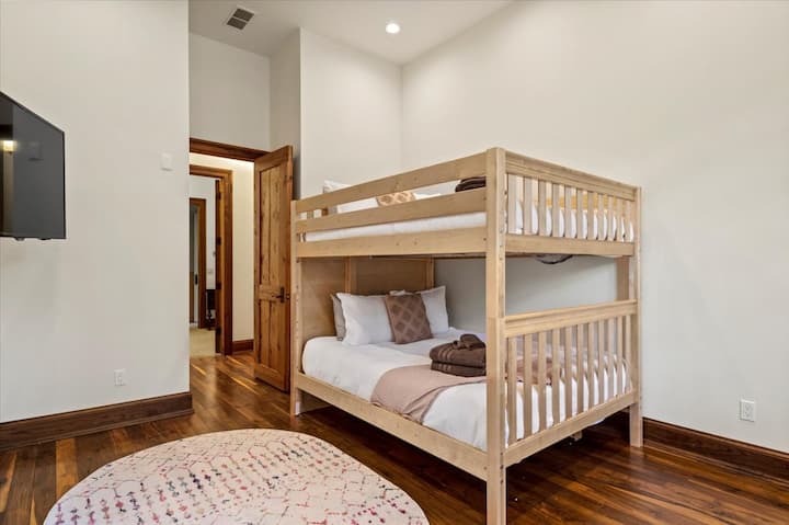 Main Level. Located on the South wing, a Queen-over-queen bunk bed. Attached to the queen bedroom, with a private entrance.