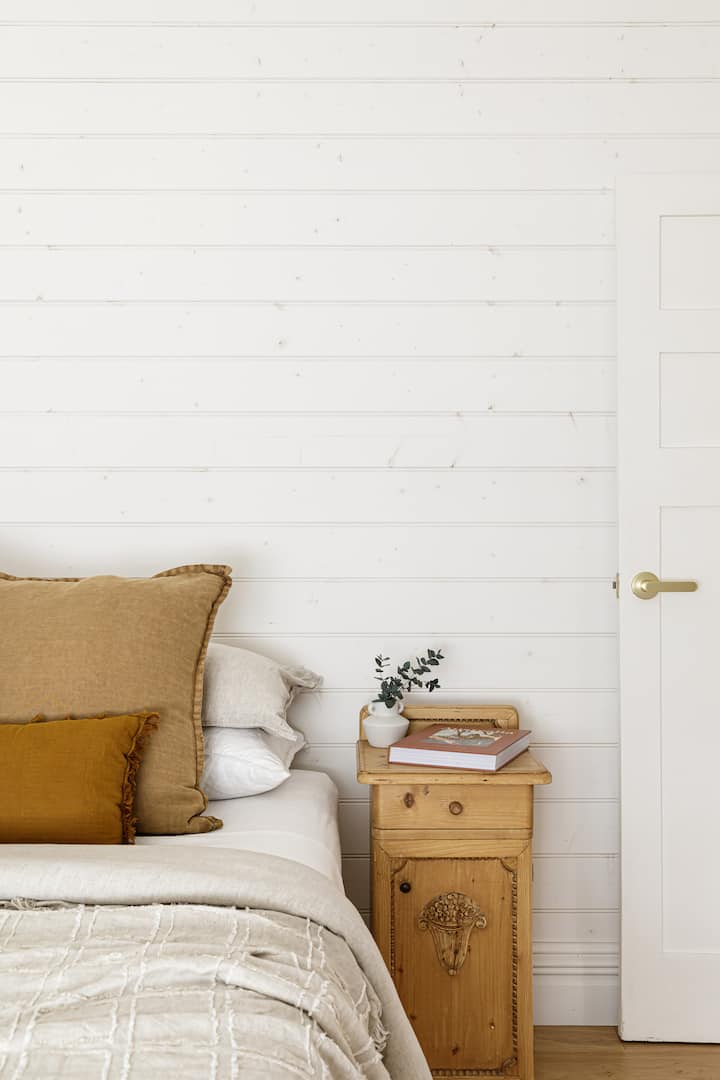 The second guest bedroom decorated with antique furniture and luxurious linens.