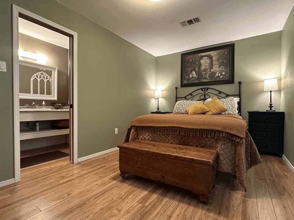 Second Bedroom Suite (Queen Bed), with Nightstands and Lamps, Full Bath, Dresser, and Chair.