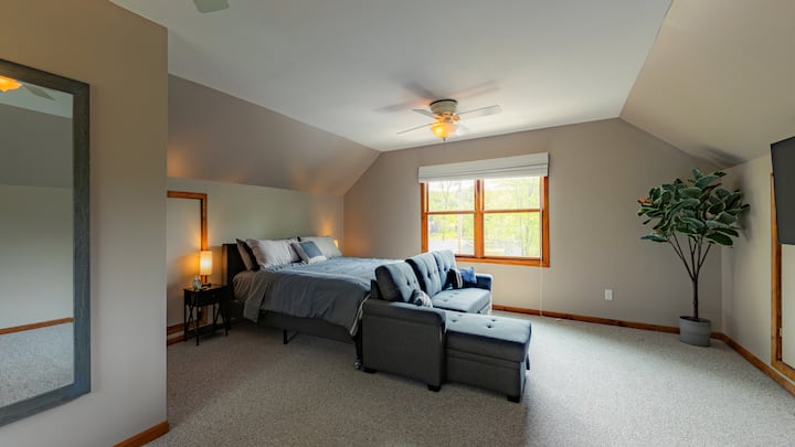 Secluded master suite w/ King size bed, Smart TV, and pull-out couch. Lamps include USB charging ports.