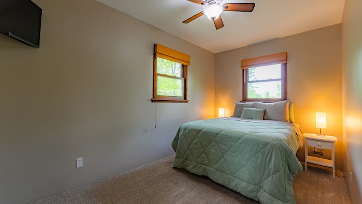 Bedroom 1 - Queen size bed & Smart TV. Lamps include USB charging ports.